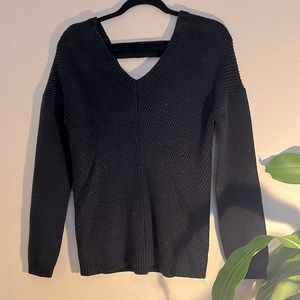 Poof sweater size small black V-neck with decorative strap on the back